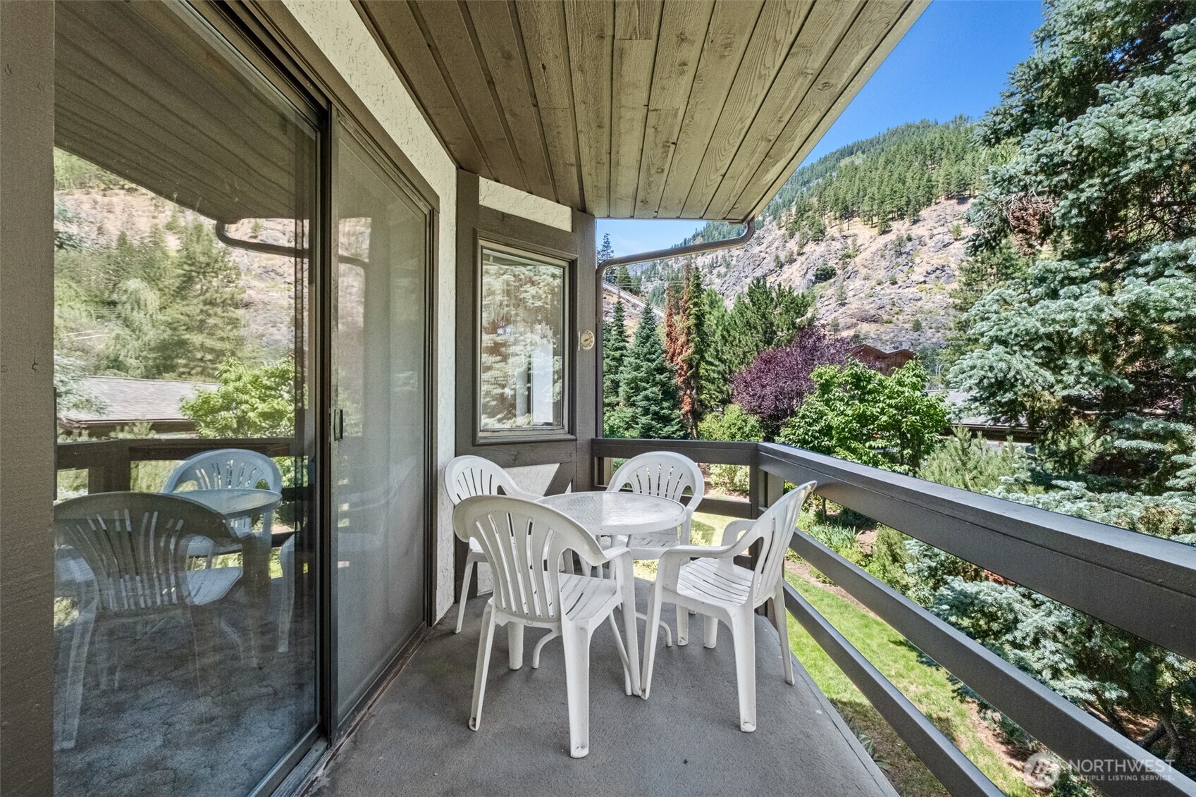 110 Icicle Road, Unit K Leavenworth, WA 98826 - Photo 7 of 26 a view of a patio with a table chairs and a backyard