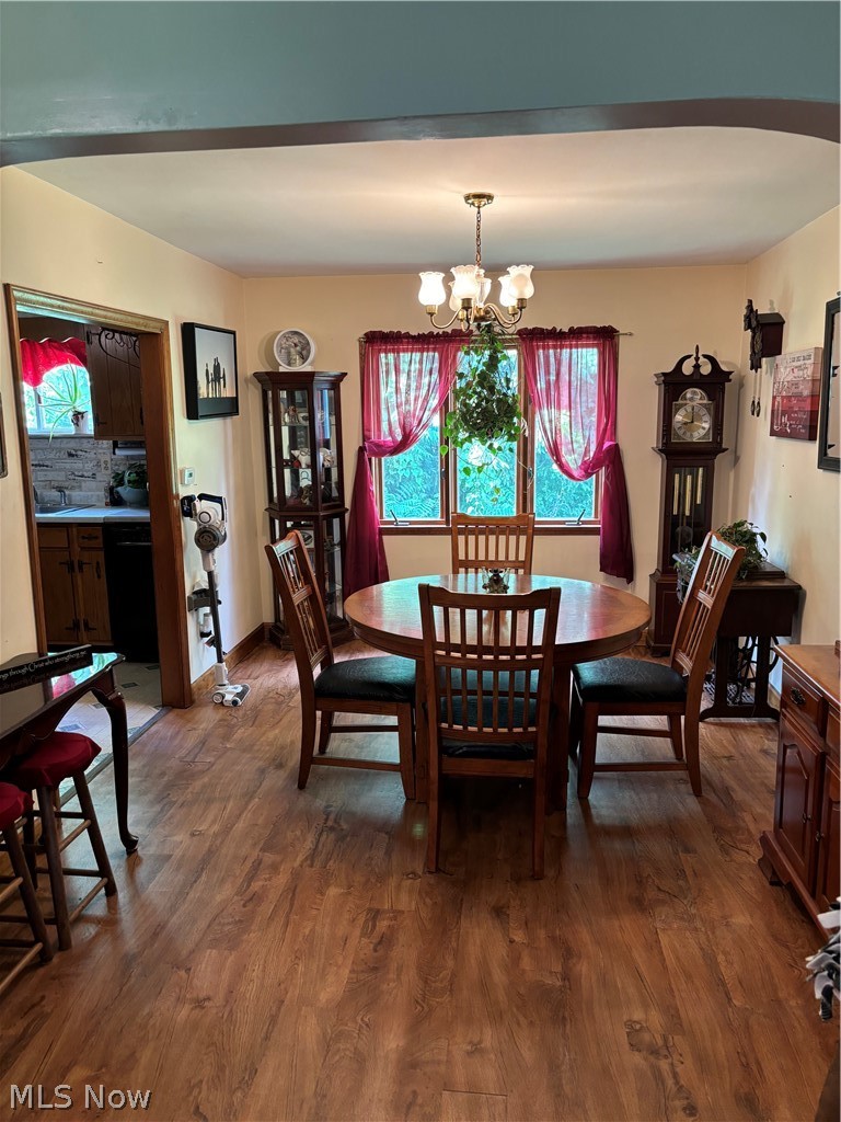 52 Old Dutch Ridge Road Parkersburg, WV 26104 - Photo 5 of 9 Dining space featuring an inviting chandelier and dark hardwood / wood-style flooring