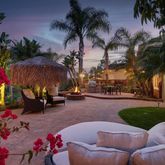 a view of a backyard with swimming pool and furniture