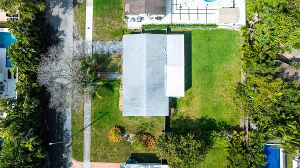 an aerial view of a house with a yard and garden