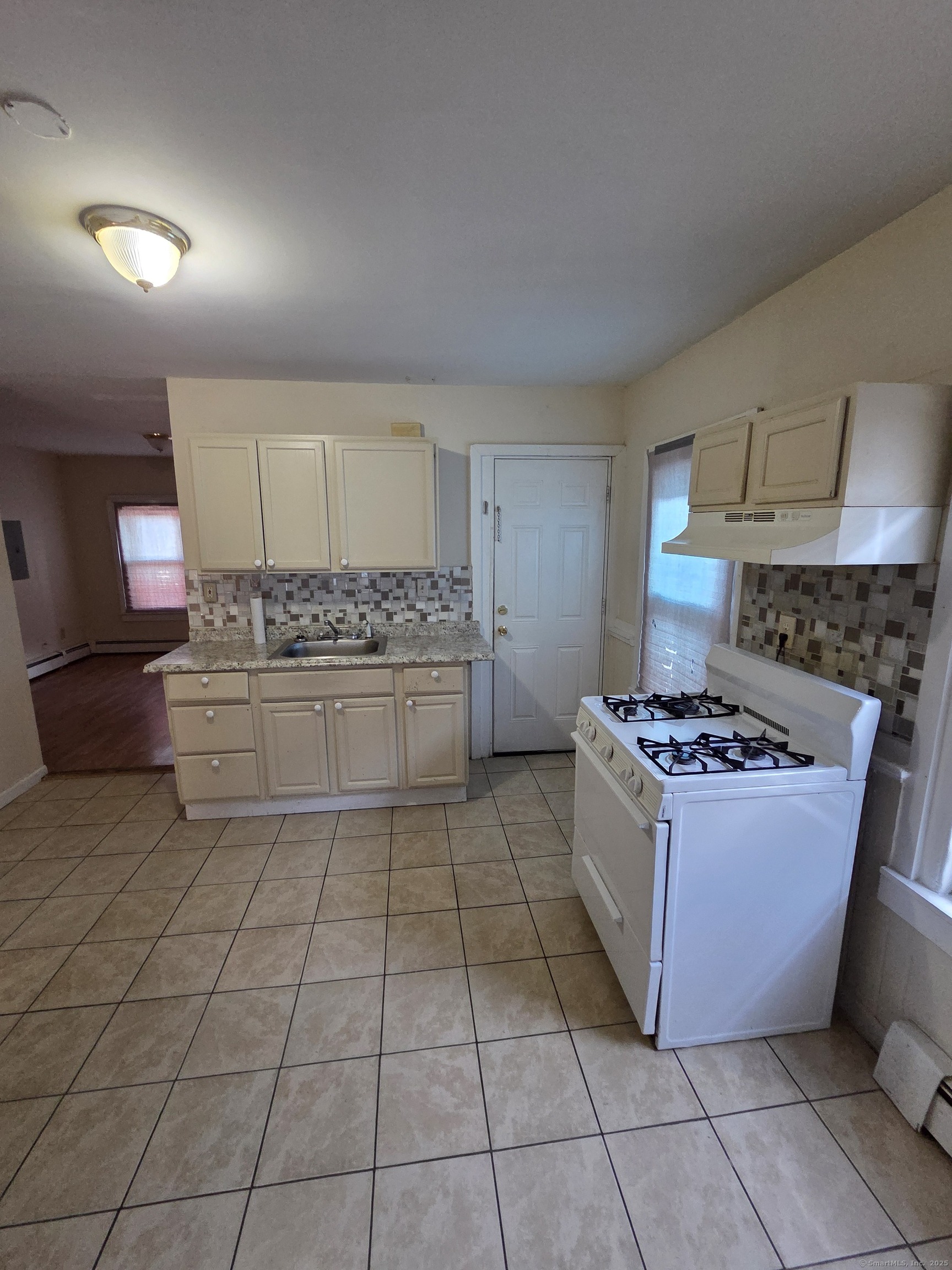 38 Walnut Street New Haven, CT 06511 - Photo 2 of 8 a kitchen with a stove top oven and cabinets