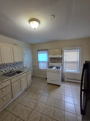 a kitchen with a stove a sink and a refrigerator