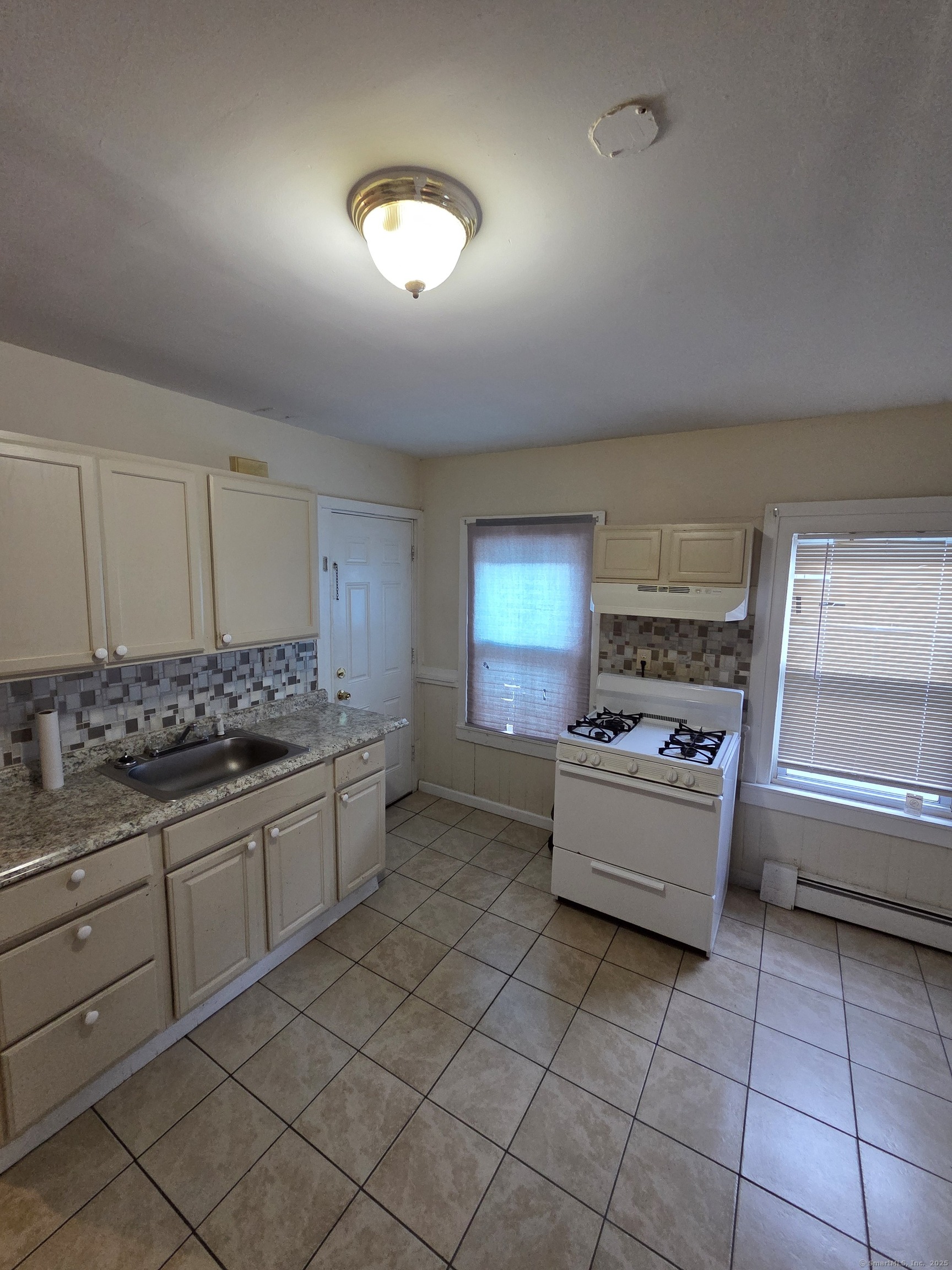 38 Walnut Street New Haven, CT 06511 - Photo 4 of 8 a kitchen with stainless steel appliances granite countertop a sink and a stove