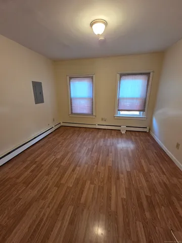 a view of room with wooden floor and window
