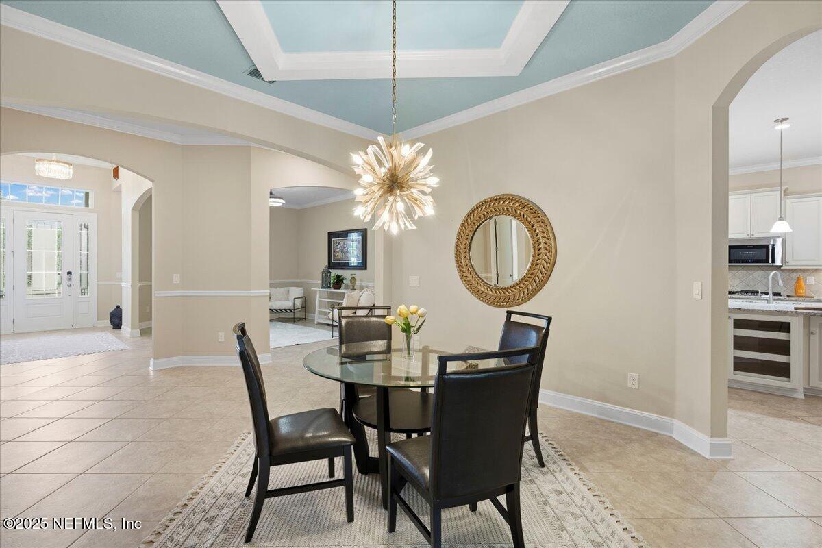 483 St Kitts Loop St. Augustine, FL 32092 - Photo 12 of 52 a dining room with furniture and a mirror