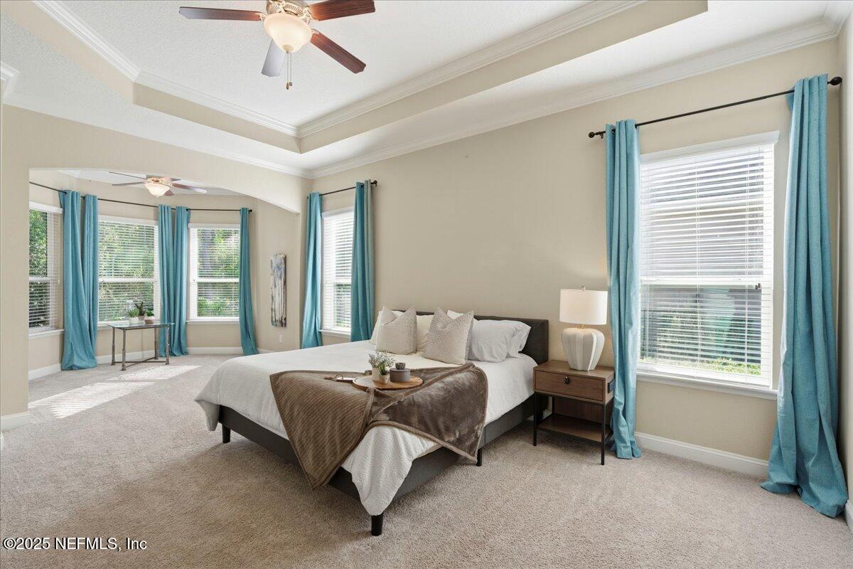 483 St Kitts Loop St. Augustine, FL 32092 - Photo 23 of 52 a bedroom with a bed and a large window