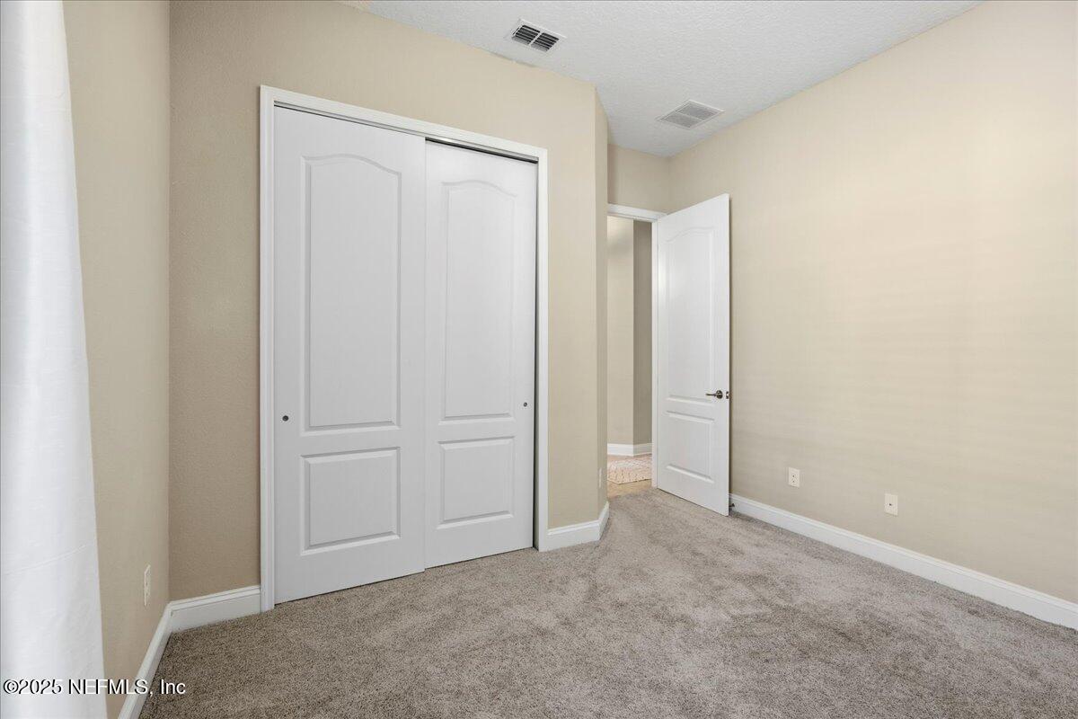 483 St Kitts Loop St. Augustine, FL 32092 - Photo 29 of 52 an empty room with closet area