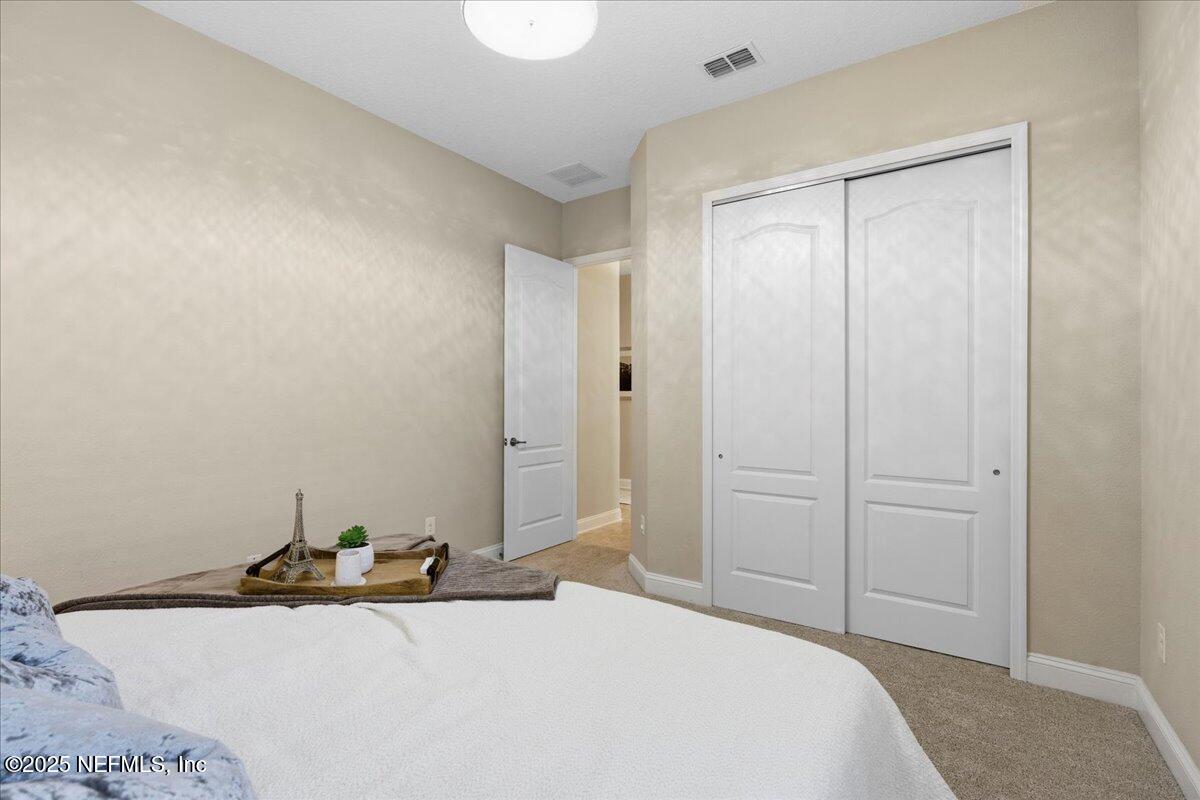 483 St Kitts Loop St. Augustine, FL 32092 - Photo 33 of 52 a bedroom with a sink and a bed