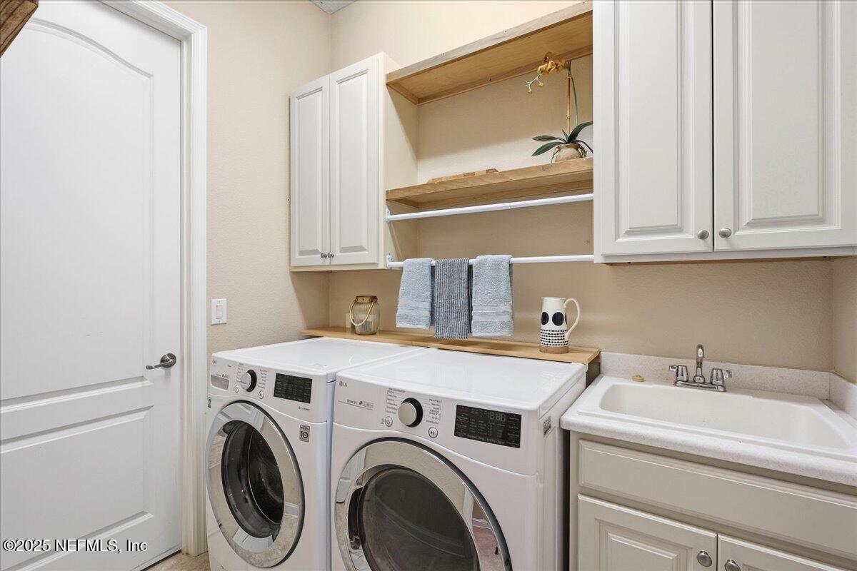 483 St Kitts Loop St. Augustine, FL 32092 - Photo 34 of 52 a utility room with dryer and washer