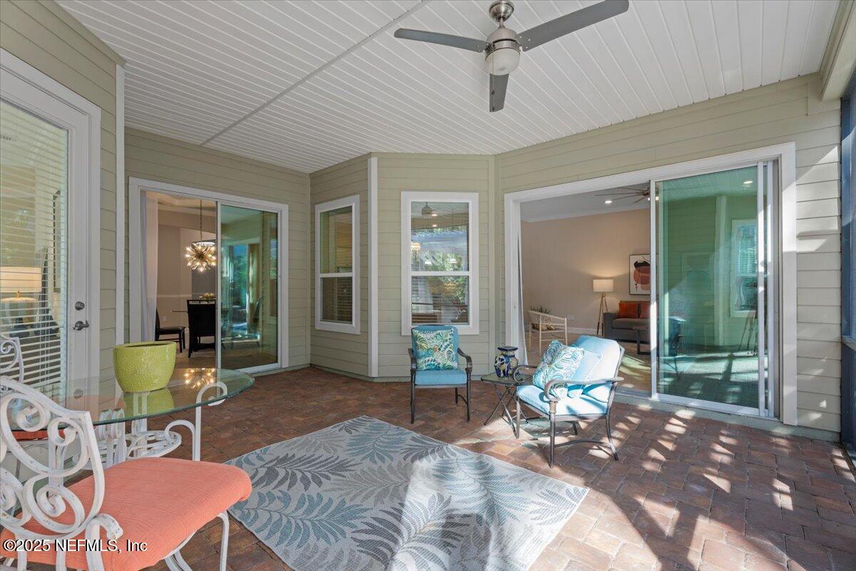 483 St Kitts Loop St. Augustine, FL 32092 - Photo 36 of 52 a living room with furniture and a outdoor space
