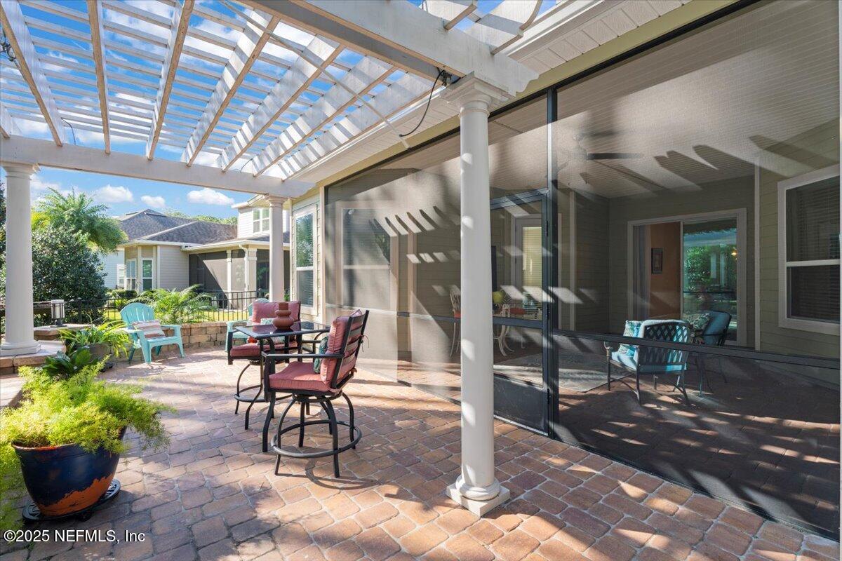 483 St Kitts Loop St. Augustine, FL 32092 - Photo 37 of 52 a view of a patio with a dining table and chairs