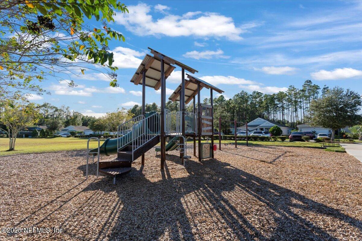 483 St Kitts Loop St. Augustine, FL 32092 - Photo 51 of 52 a house view with a sitting space fire pit and outdoor space