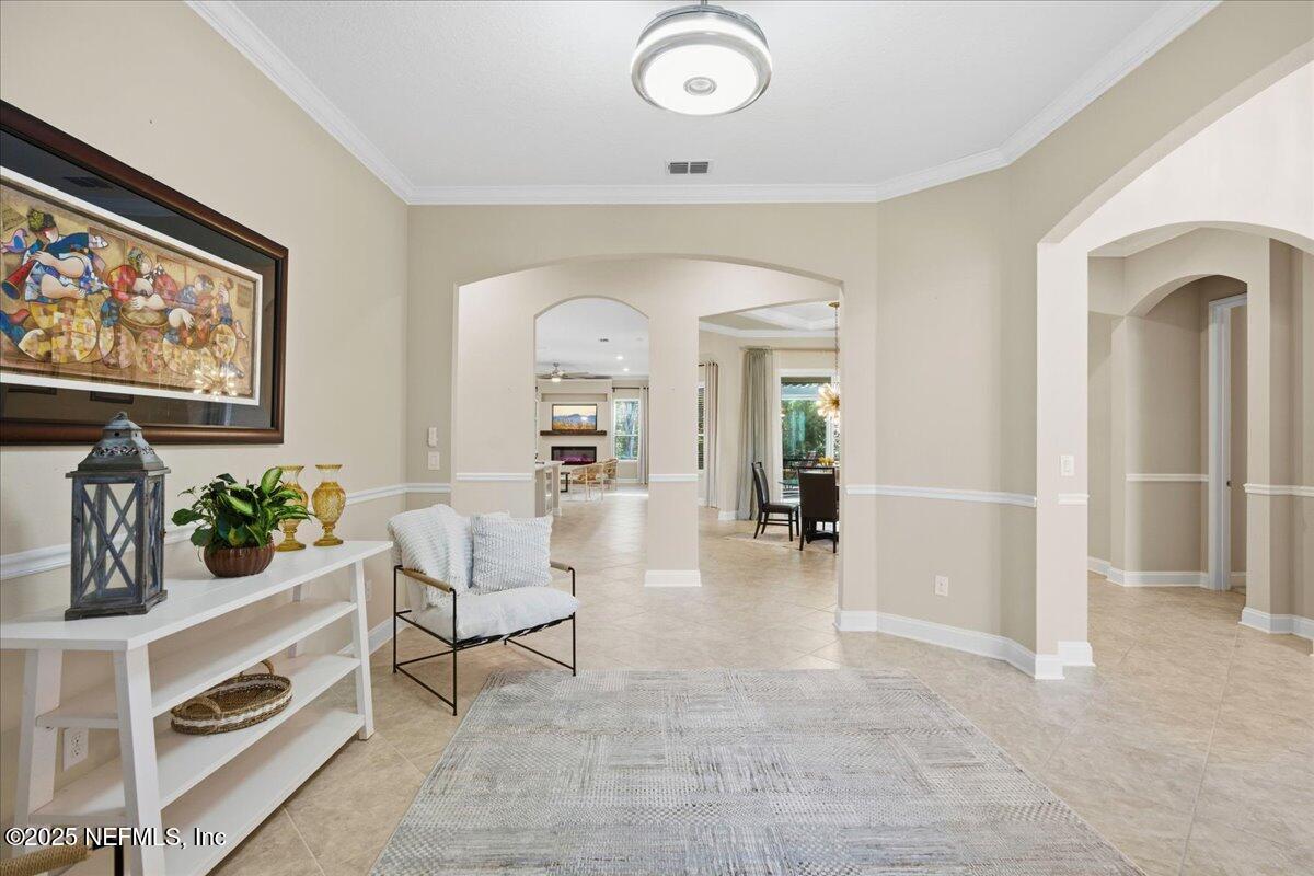 483 St Kitts Loop St. Augustine, FL 32092 - Photo 9 of 52 a living room with furniture and a flat screen tv