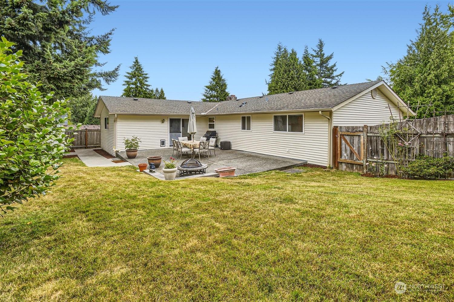22020 6th Avenue West Bothell, WA 98021 - Photo 27 of 28 a house view with swimming pool and trees in the background
