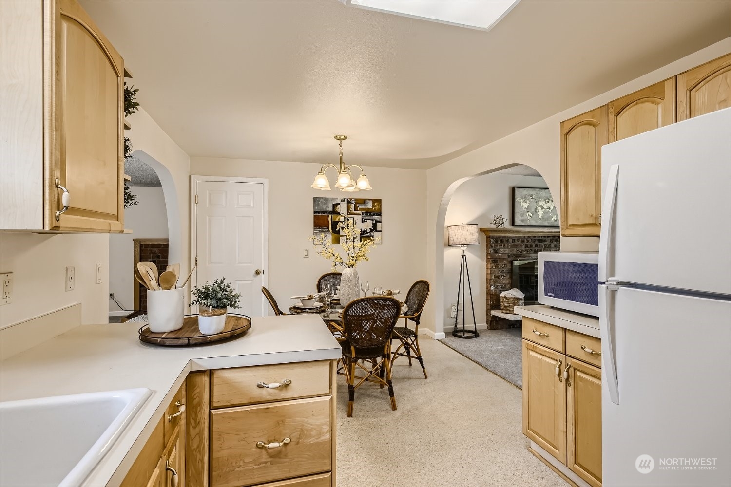 22020 6th Avenue West Bothell, WA 98021 - Photo 8 of 28 a kitchen with refrigerator a stove a dining table and chairs