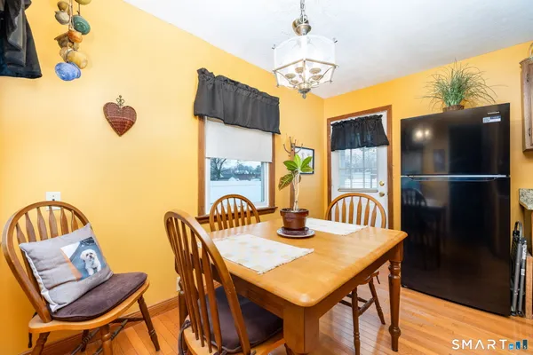 a view of a dining room with furniture and chandelier