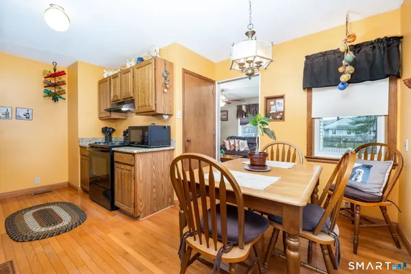 a view of a dining room with furniture and wooden floor