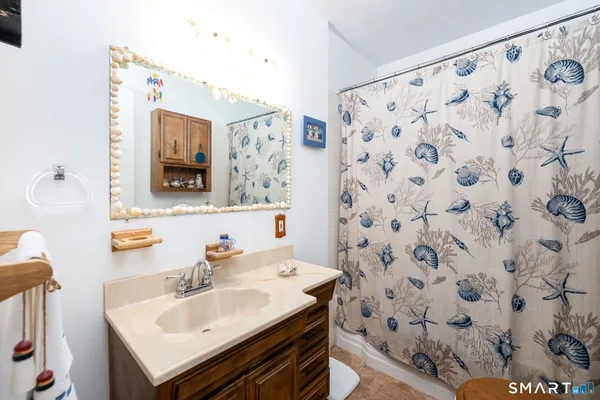 a bathroom with a tub sink and mirror