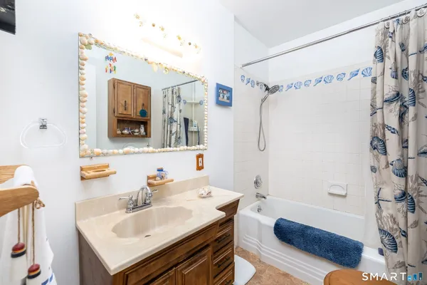 a view of a workspace with furniture and a bookshelf