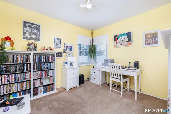 a living room with furniture and a book shelf