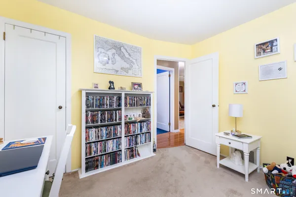 a bedroom with a bed and flat tv screen on dresser