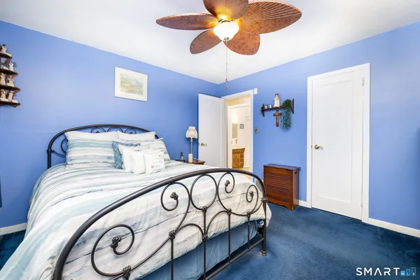 a living room with furniture and a book shelf