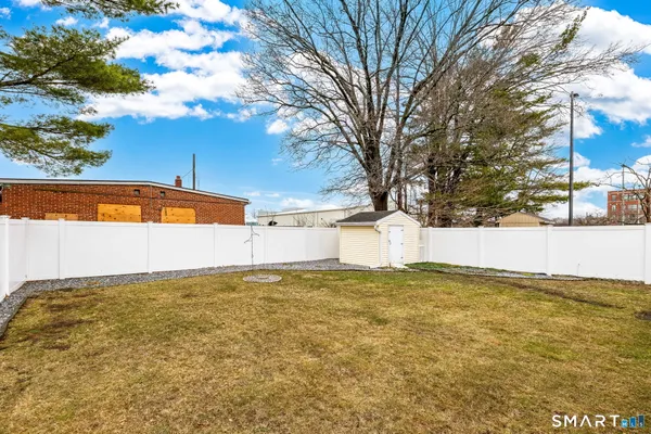 a view of a house with a yard and covered with snow in the background