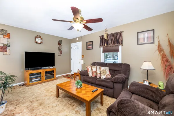 a living room with furniture and a flat screen tv