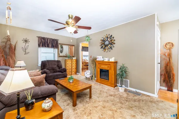 a living room with furniture a fireplace and a flat screen tv