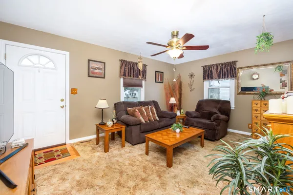 a living room with furniture and wooden floor