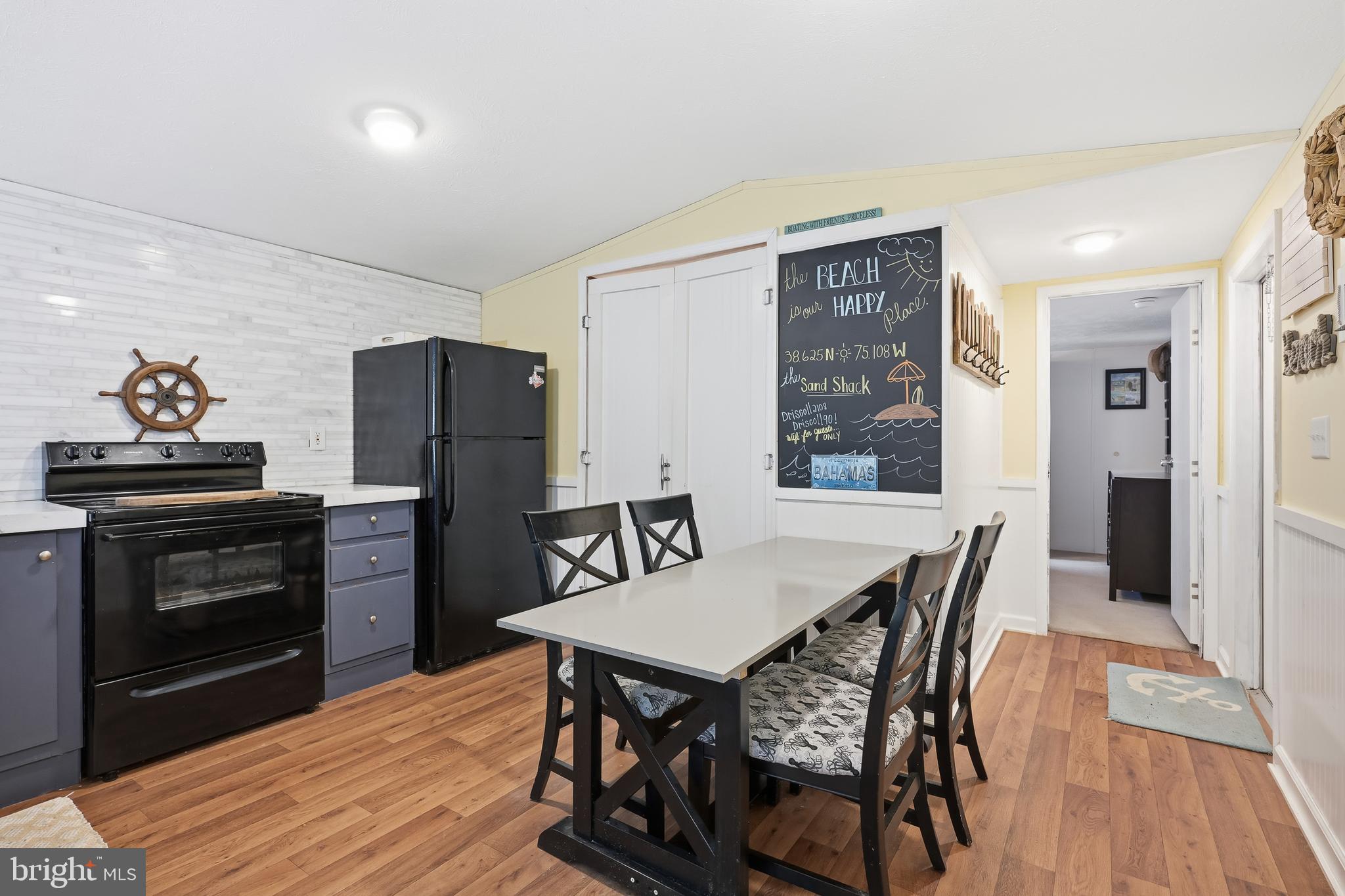 35390 Teal Road, Unit 314 Millsboro, DE 19966 - Photo 6 of 23 a view of a dining room with furniture and wooden floor