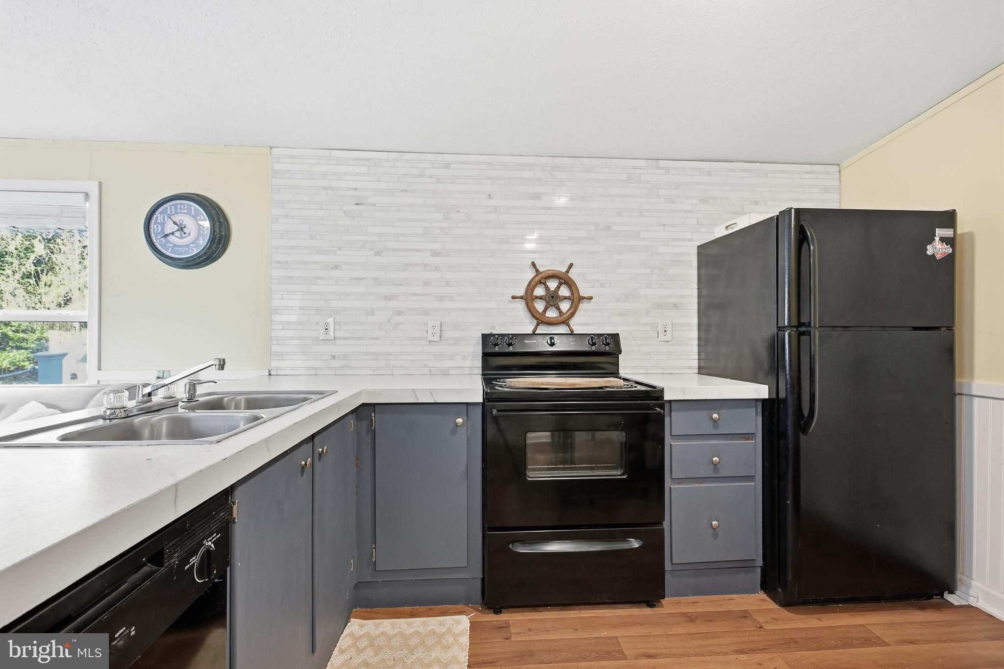 35390 Teal Road, Unit 314 Millsboro, DE 19966 - Photo 7 of 23 a kitchen with stainless steel appliances a stove refrigerator and sink