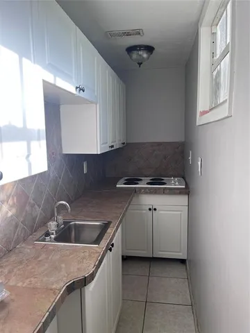 a kitchen with a sink and cabinets