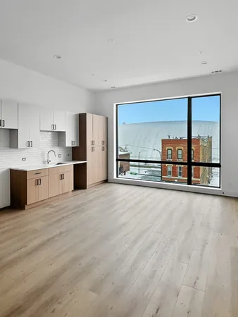 a view of kitchen and kitchen with wooden floor