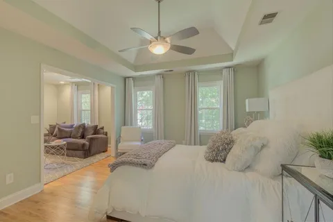 a bedroom with a bed and ceiling fan