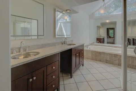 a bathroom with a double vanity sink mirror and