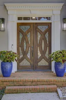 a front view of a wooden door with washer and dryer