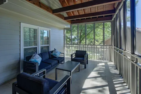 a living room with furniture and a floor to ceiling window