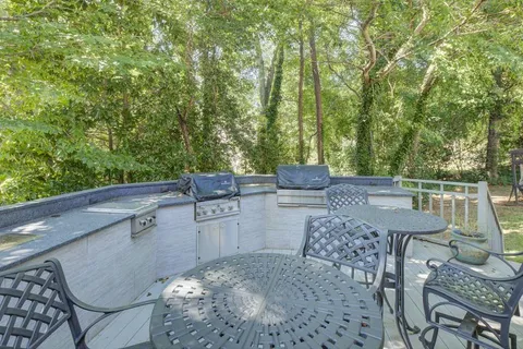 a view of balcony with table and chairs