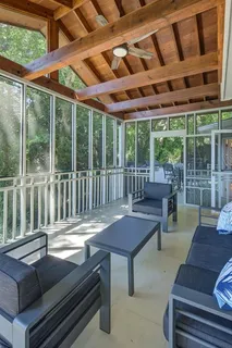 a outdoor living space with patio furniture and wooden floor