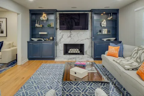 a living room with furniture and a fireplace