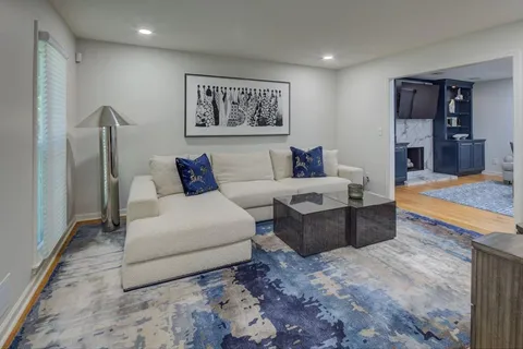 a living room with furniture and a rug