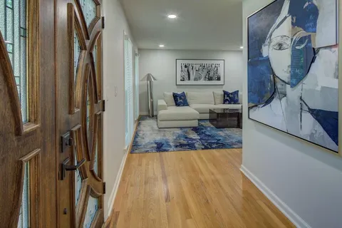 a living room with furniture and a mirror