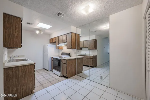 a kitchen with stainless steel appliances a sink stove top oven and cabinets