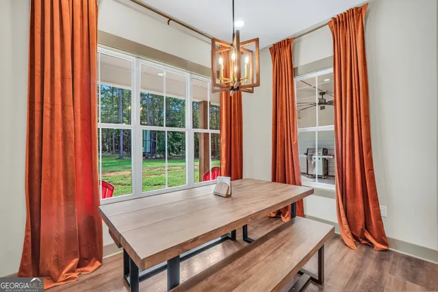 a kitchen with stainless steel appliances granite countertop a sink a stove and a wooden floors