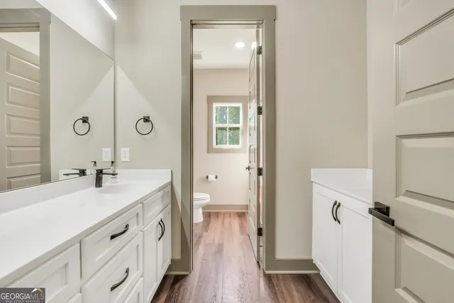 a view of swimming pool with trees and yard in back