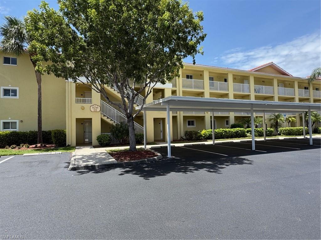 8244 Key Royal Circle, Unit 615 Naples, FL 34119 - Photo 13 of 23 View of building exterior with covered parking and stairs