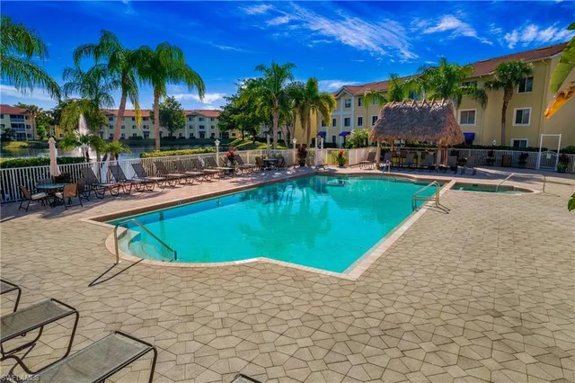a swimming pool with outdoor seating and yard