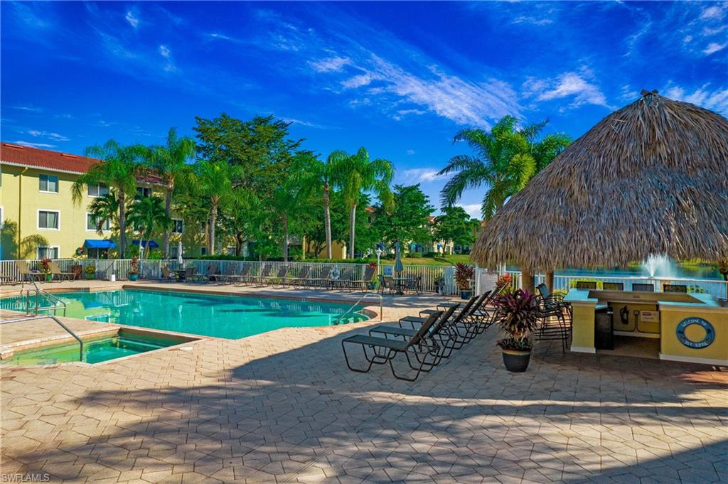 8244 Key Royal Circle, Unit 615 Naples, FL 34119 - Photo 16 of 23 Community pool with a patio area and a community hot tub
