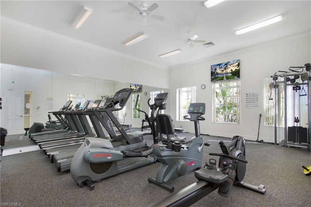 8244 Key Royal Circle, Unit 615 Naples, FL 34119 - Photo 19 of 23 Exercise room featuring ornamental molding and a ceiling fan